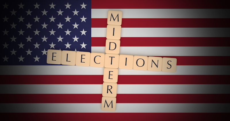 tiles spelling out midterm elections on flag background